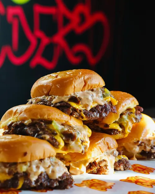 A pile of Chris N Eddy’s smash sliders against red graffiti neon
